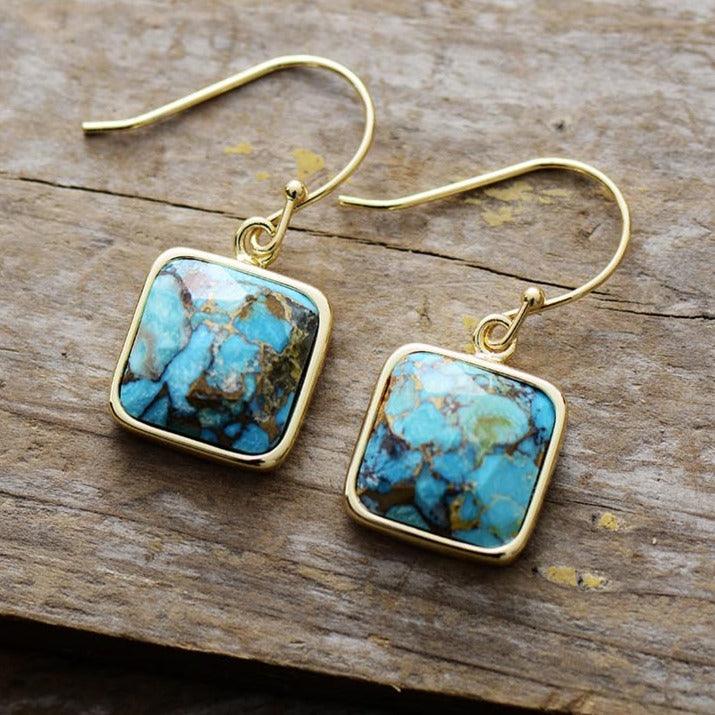 Handmade turquoise square earrings, elegant design, gold finish, displayed on wooden surface. Turquoise Square Drop Earrings | ALLORA JADE