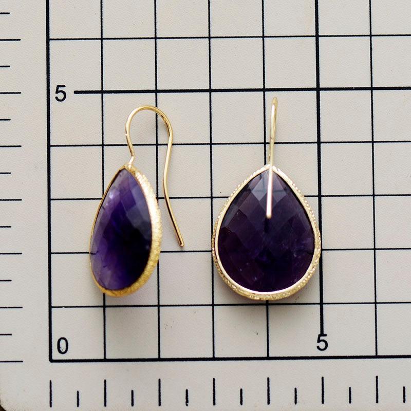 Faceted Amethyst gemstone earrings – elegant teardrop design - displayed on size chart background - Allora Jade