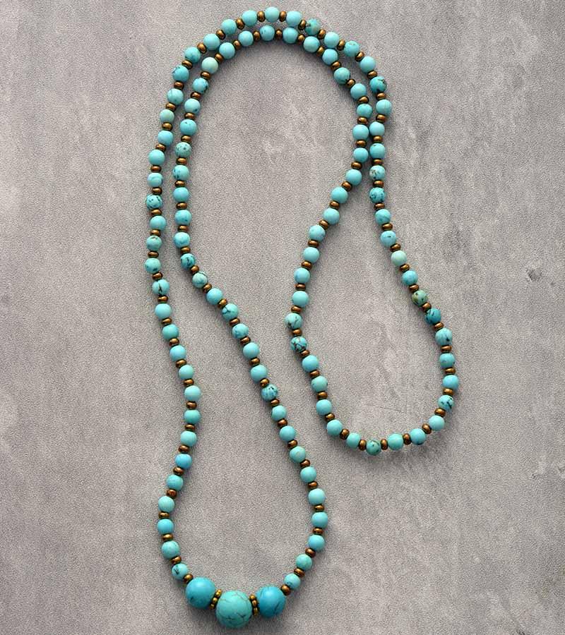 Turquoise bead beaded necklace or wear as bracelet with gold spacers on grey background. ALLORA JADE