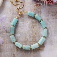 Amazonite beaded bracelet with gold accents on a textured surface