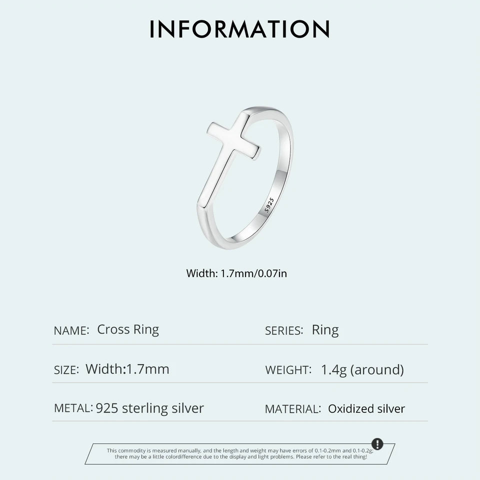 Silver cross ring with product details on a white background