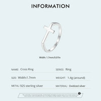 Silver cross ring with product details on a white background