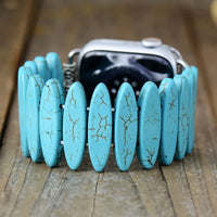 Turquoise stone bracelet on a wooden surface. Turquoise Beads Stretchy Apple Watch Band | ALLORA JADE