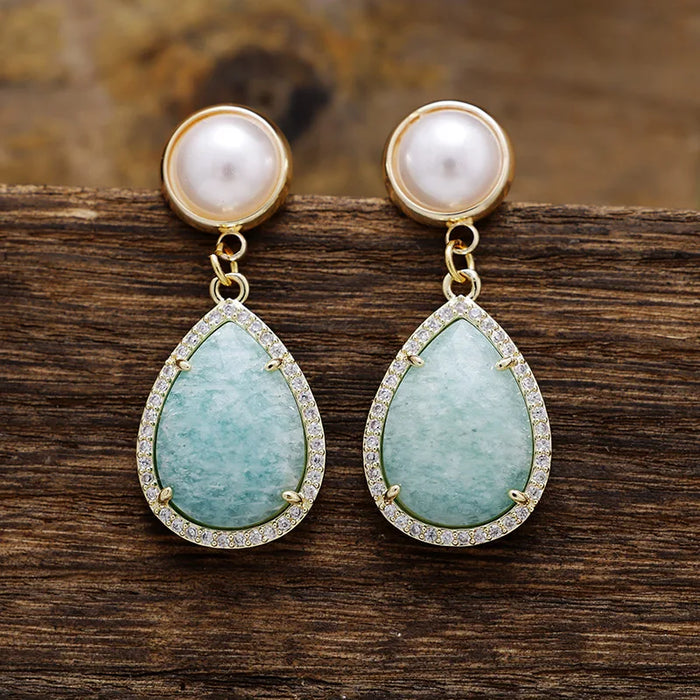 Amazonite Pavé Teardrop Dangle Earrings featuring blue-green gemstone drops framed by sparkling rhinestones, with imitation pearl studs in gold-coloured settings.
