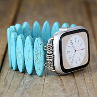 Smartwatch with decorative band on a wooden surface. Turquoise Beads Stretchy Apple Watch Band | ALLORA JADE