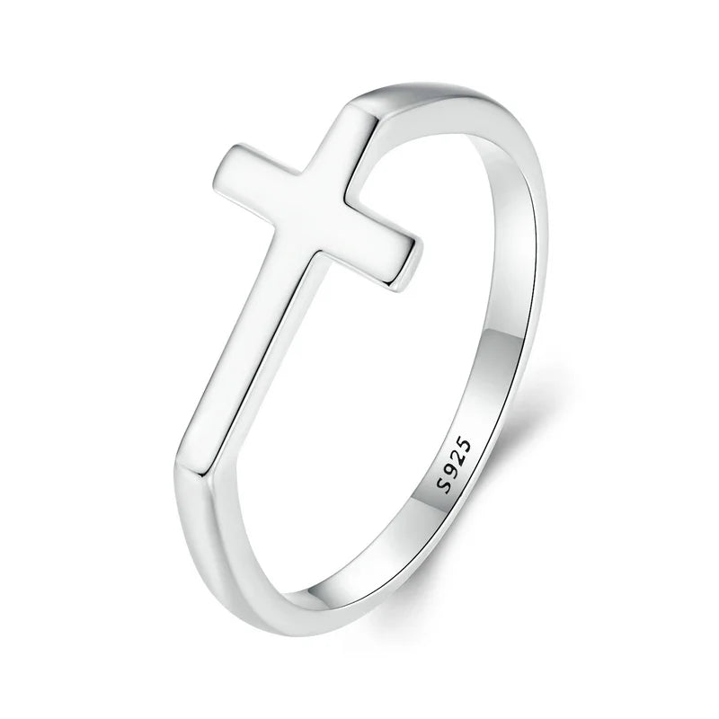 Silver ring with a cross design on a white background