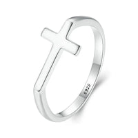 Silver ring with a cross design on a white background