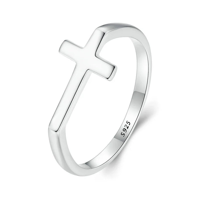 Silver ring with a cross design on a white background