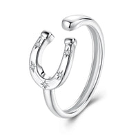 Silver ring with horseshoe design and small diamonds on a white background