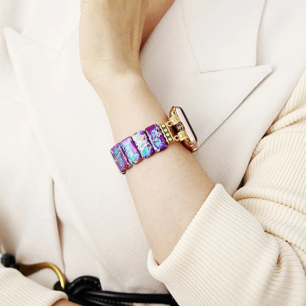 Multicolored bracelet on a person's wrist with a neutral background. Purple Aqua Jasper Stretchy Apple Watch Band - gold | ALLORA JADE