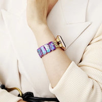 Multicolored bracelet on a person's wrist with a neutral background. Purple Aqua Jasper Stretchy Apple Watch Band - gold | ALLORA JADE