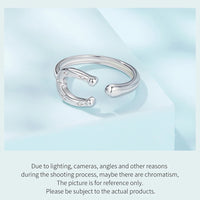 Silver horseshoe open ring on a light blue background