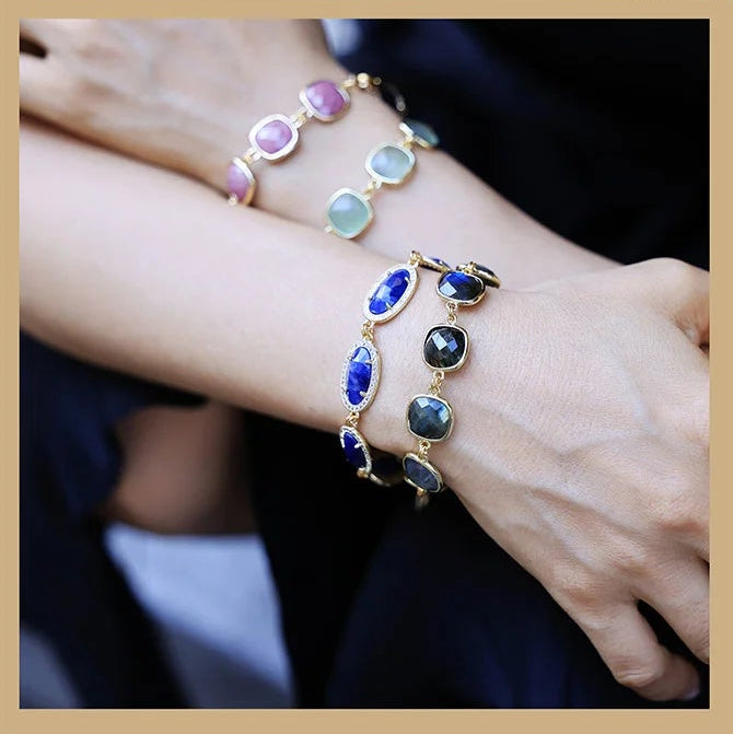 Model wearing blue and pink beaded bracelets.