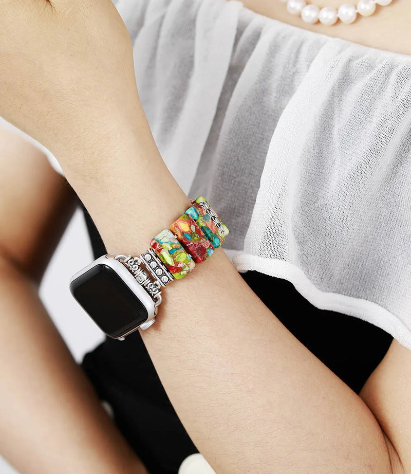 Colourful beaded bracelet on a wrist with a blurred background. Flower Jasper Stretchy Apple Watch Band | ALLORA JADE