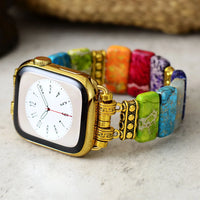 Colourful beaded bracelet with a gold clasp on a marble surface. 7 Chakras Jasper Stretchy Apple Watch Band | ALLORA JADE
