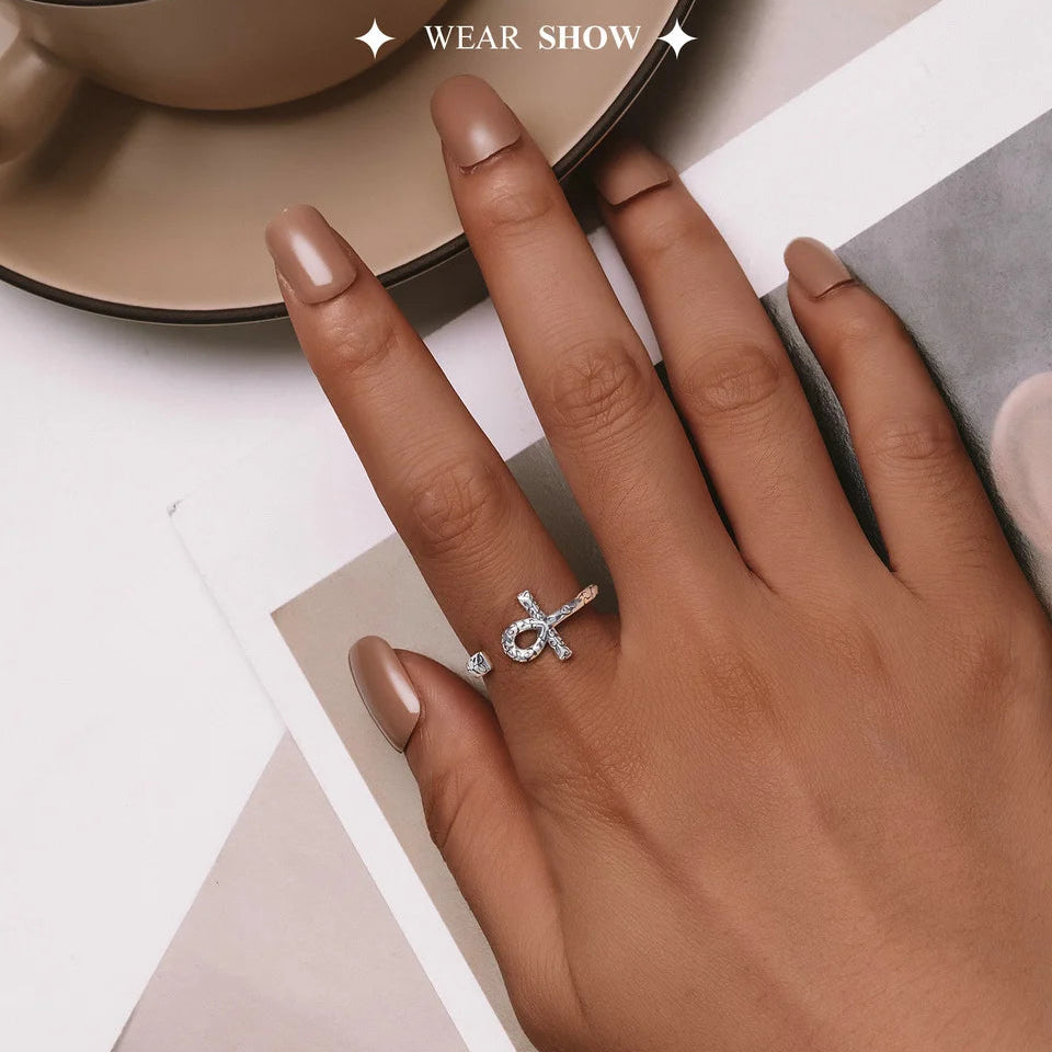 Hand wearing an Ankh Egyptian Cross Sterling Silver Ring on a neutral background