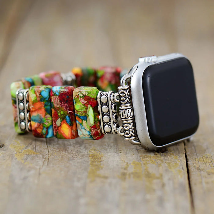 Colourful beaded watch band on a smartwatch with a rustic wooden background. Flower Jasper Stretchy Apple Watch Band | ALLORA JADE